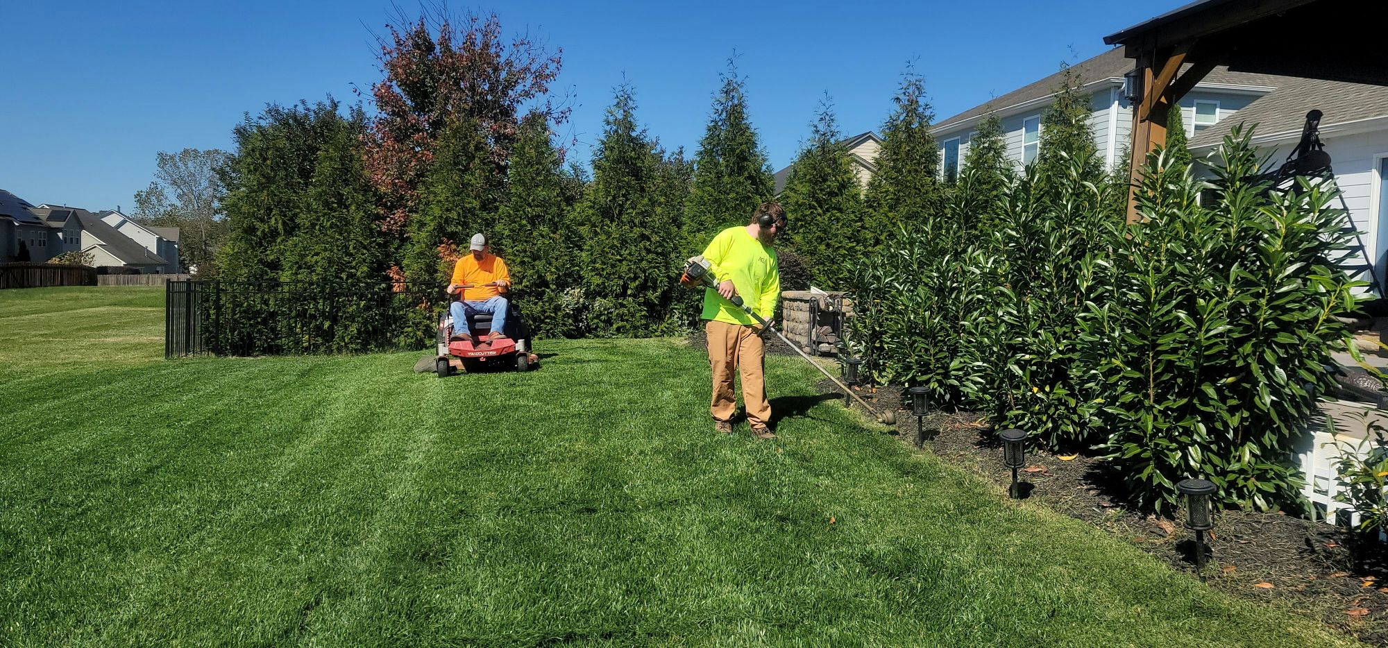 Gardener mowing a lawn