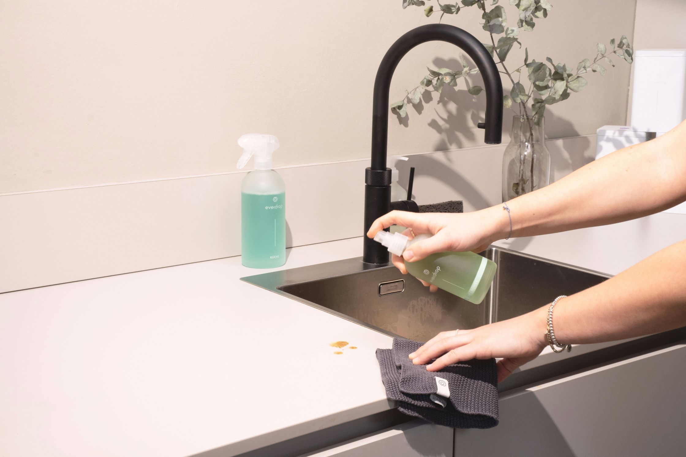 Cleaner wiping down a kitchen counter